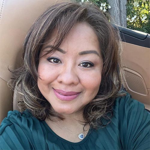 Olga, one of RedwoodESL's tutors, smiling at the camera