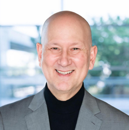 Pete H, one of RedwoodESL's tutors, smiling at the camera